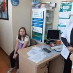 Dziewczynka siedzi na krześle w gabinecie pielęgniarki