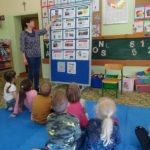 Bibliotekarka na podstawie ilustracji opowiada przedszkolakom, jak powstaje książka.